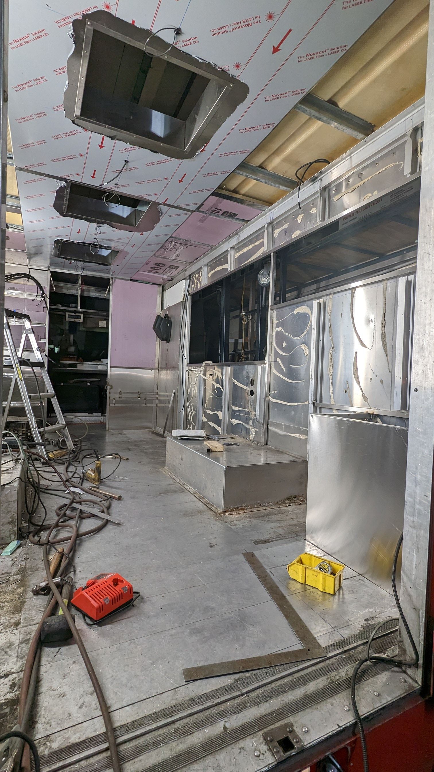 The inside of a food truck is being remodeled.