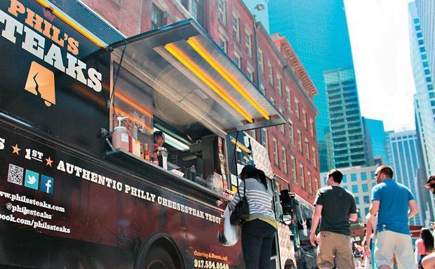 A phil 's steaks food truck is parked on a city street