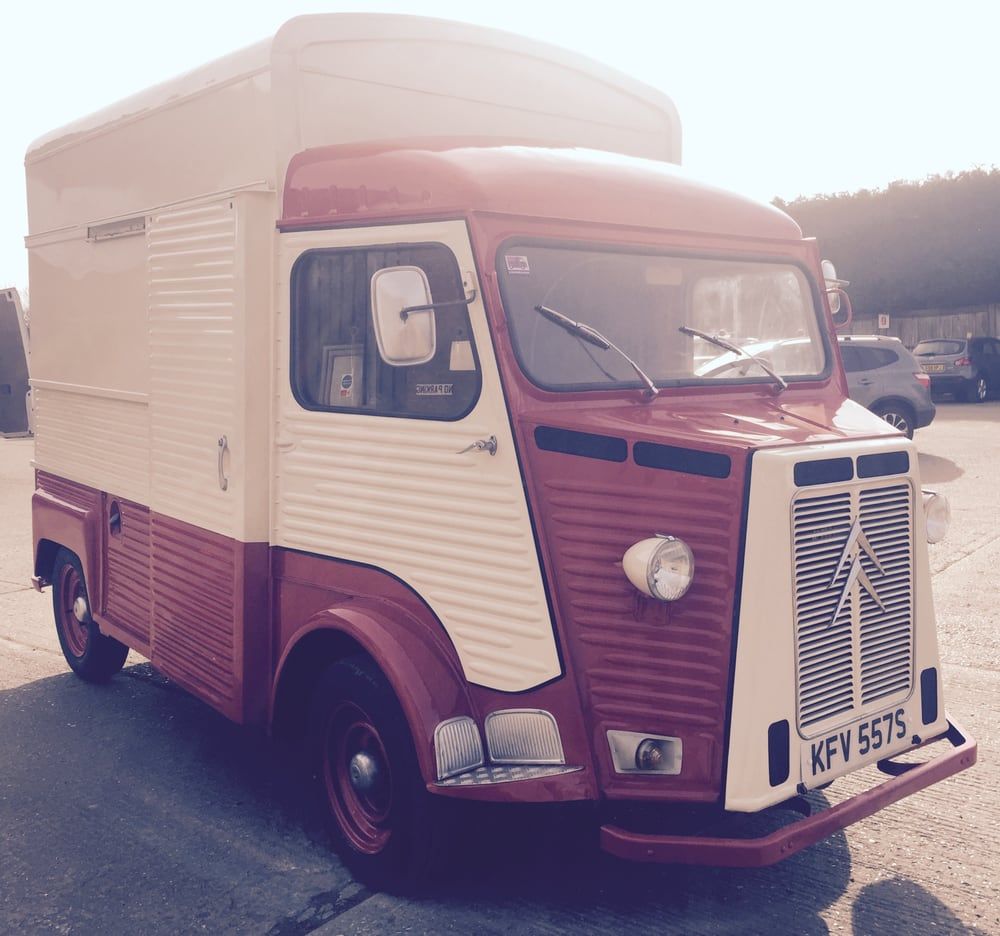 A red and white truck with a license plate that says kfv 5975