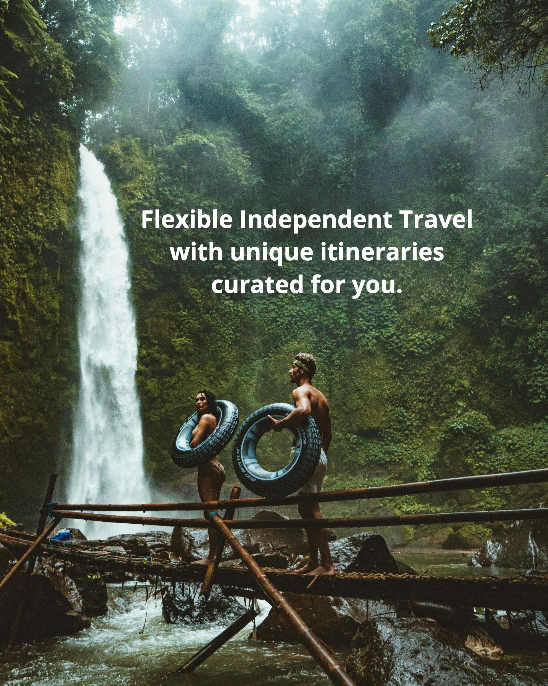 A man and a woman are standing on a bridge in front of a waterfall.