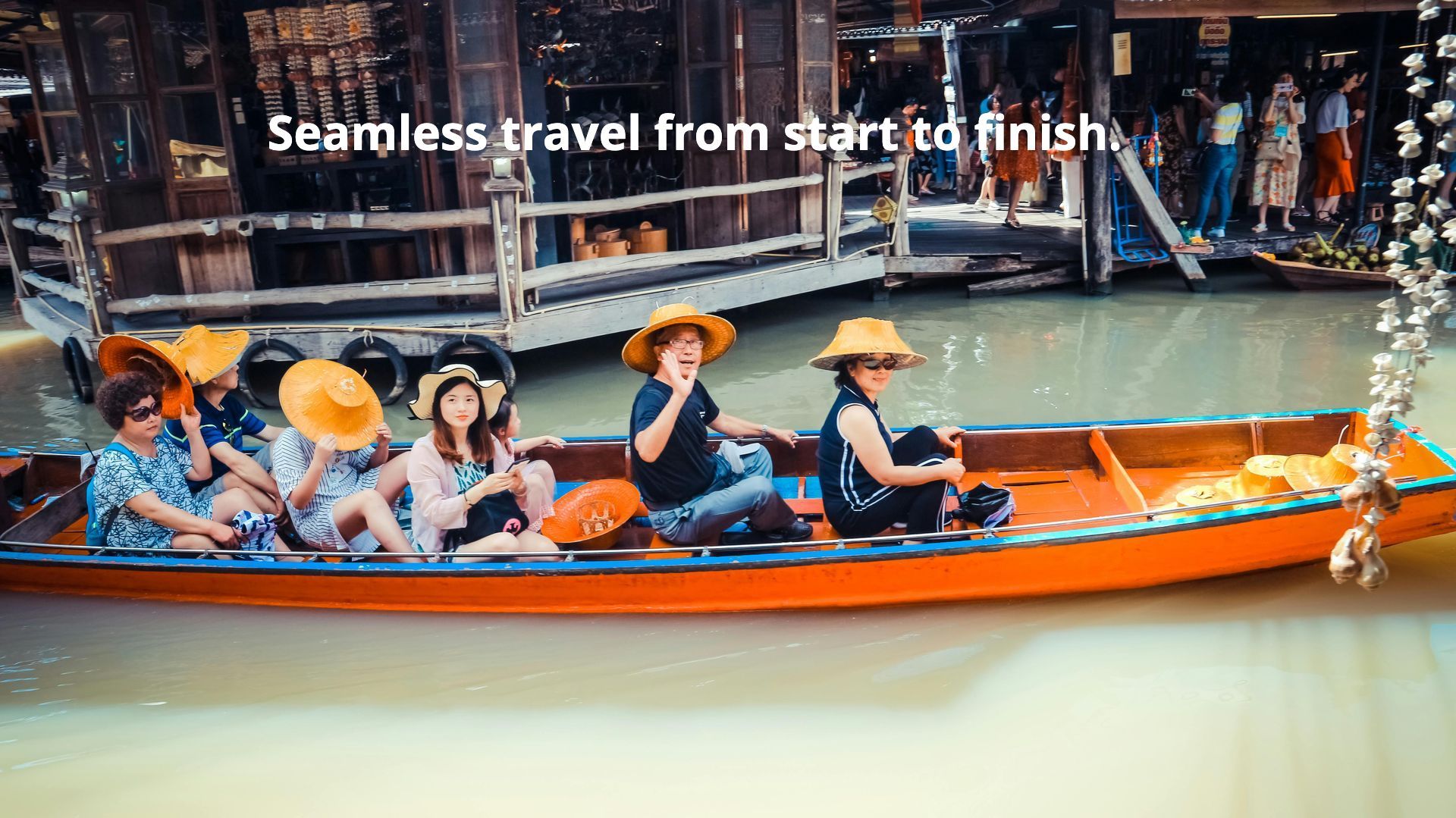 A group of people are sitting in a boat on a river.