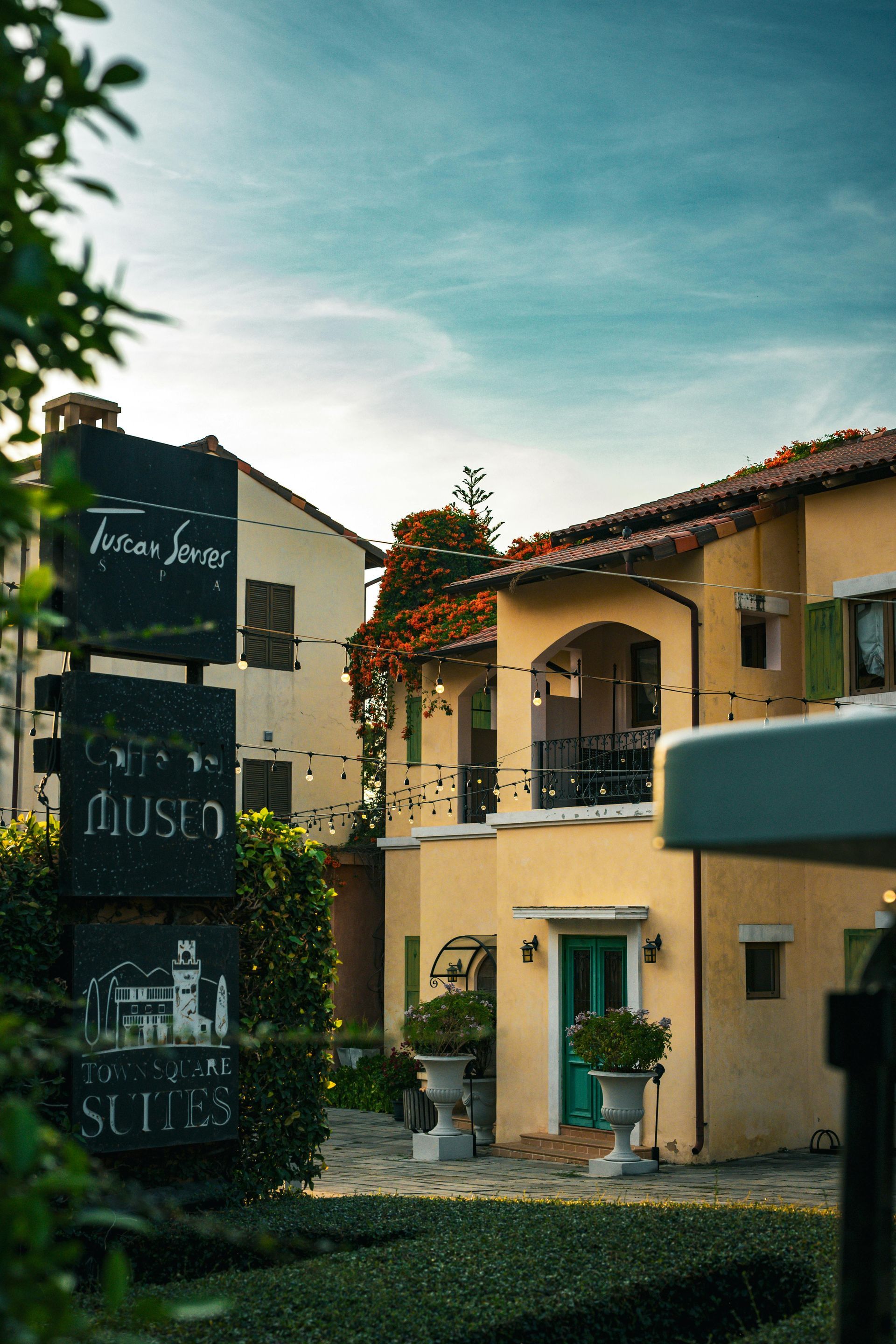 A large yellow house with a sign in front of it.