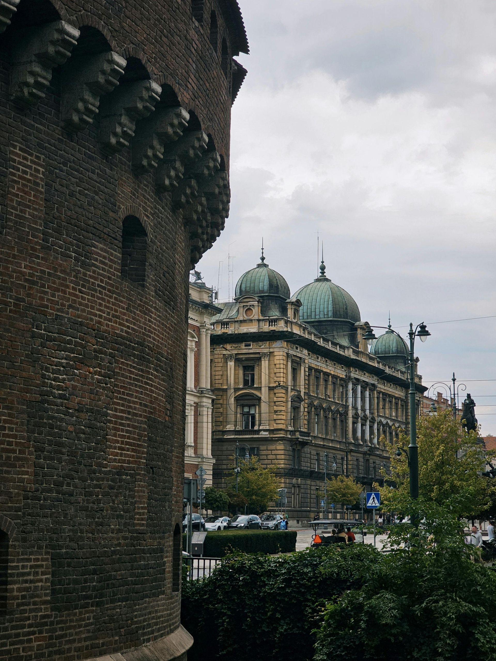 A brick building with a dome on top of it in a city.
