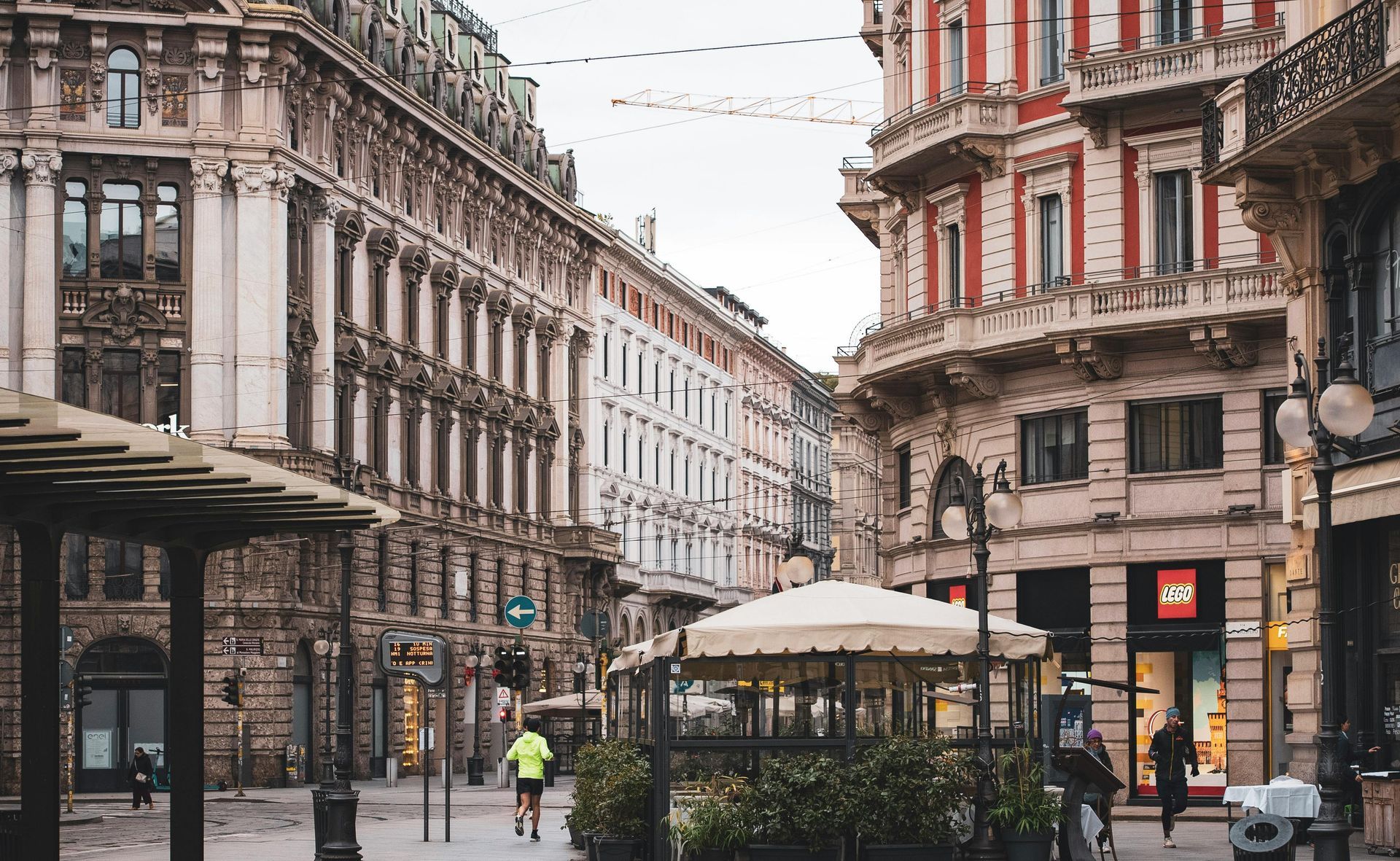 A city street with a lot of buildings and umbrellas