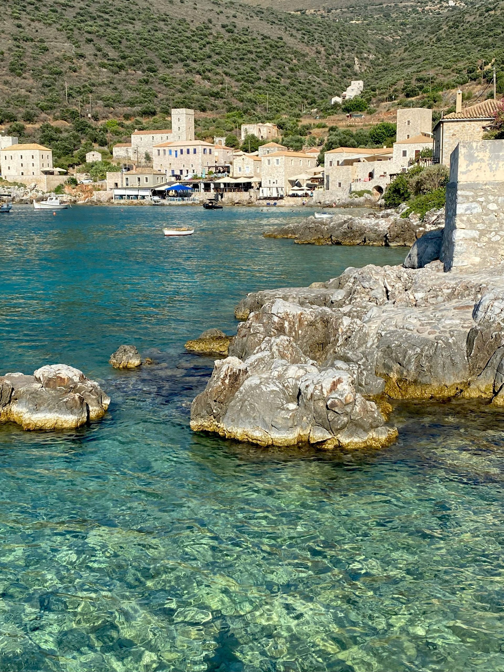 A large body of water with a small town in the background.