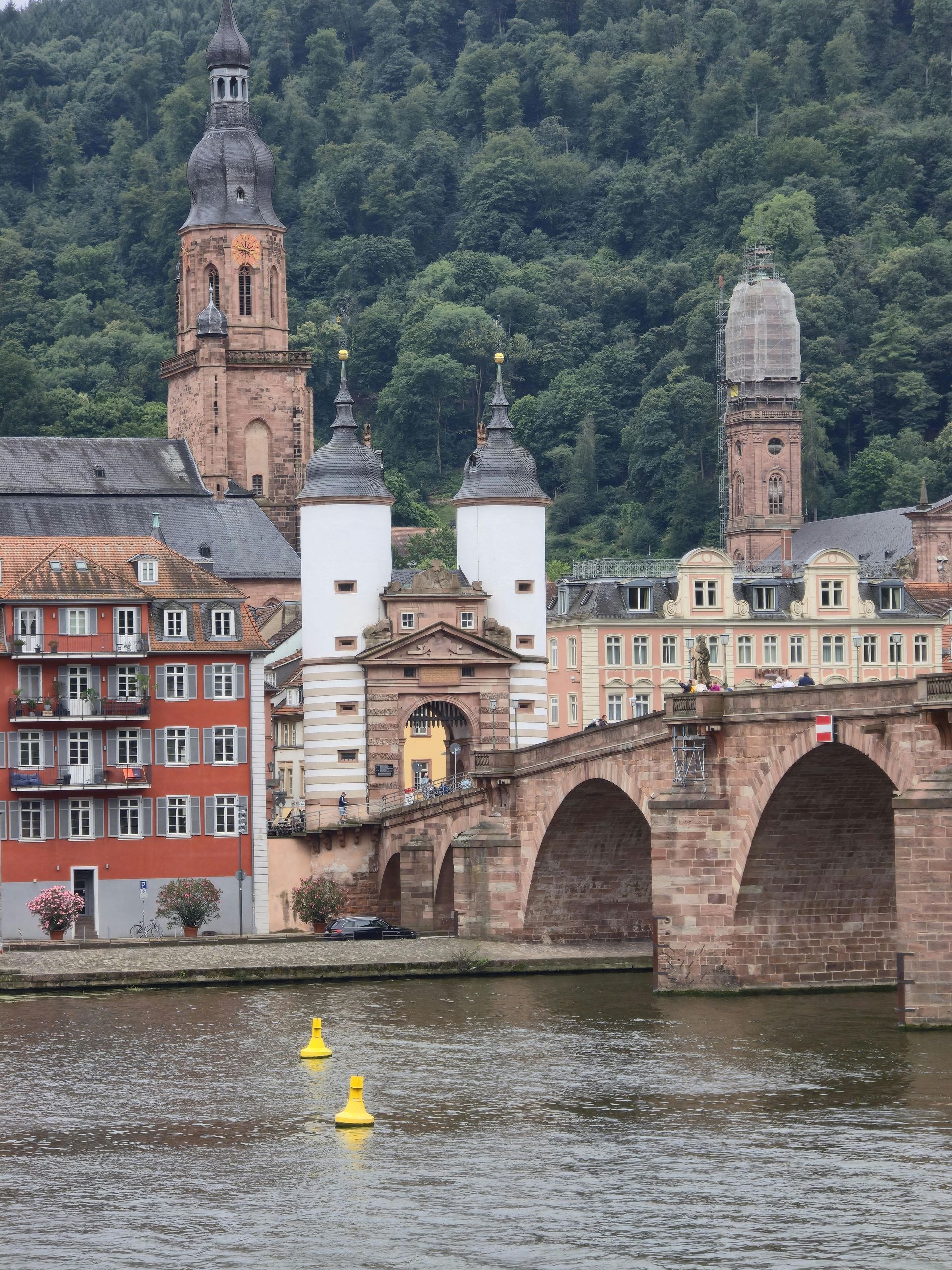 A bridge over a river with buildings in the background
