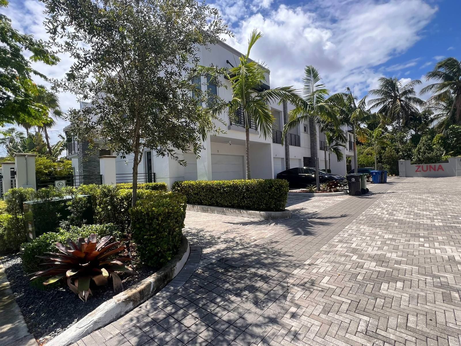 green trees surrounding properties