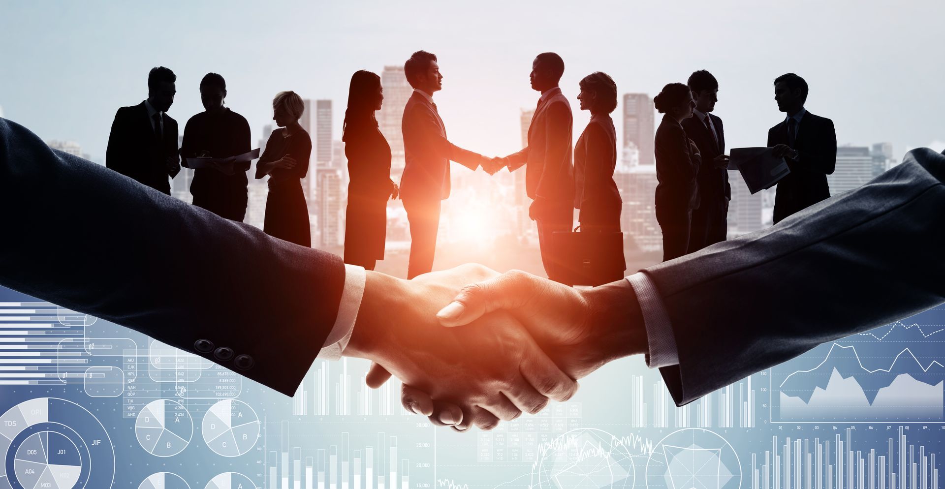 A group of business people are shaking hands in front of a city skyline.