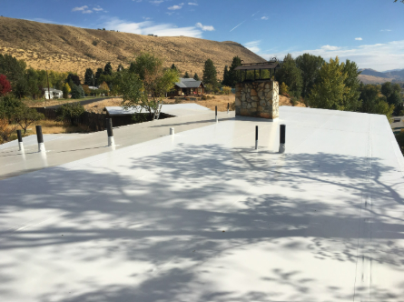 A white roof with a chimney on top of it.