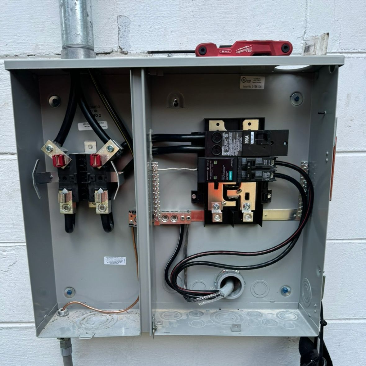 A electrical box with a screwdriver on top of it