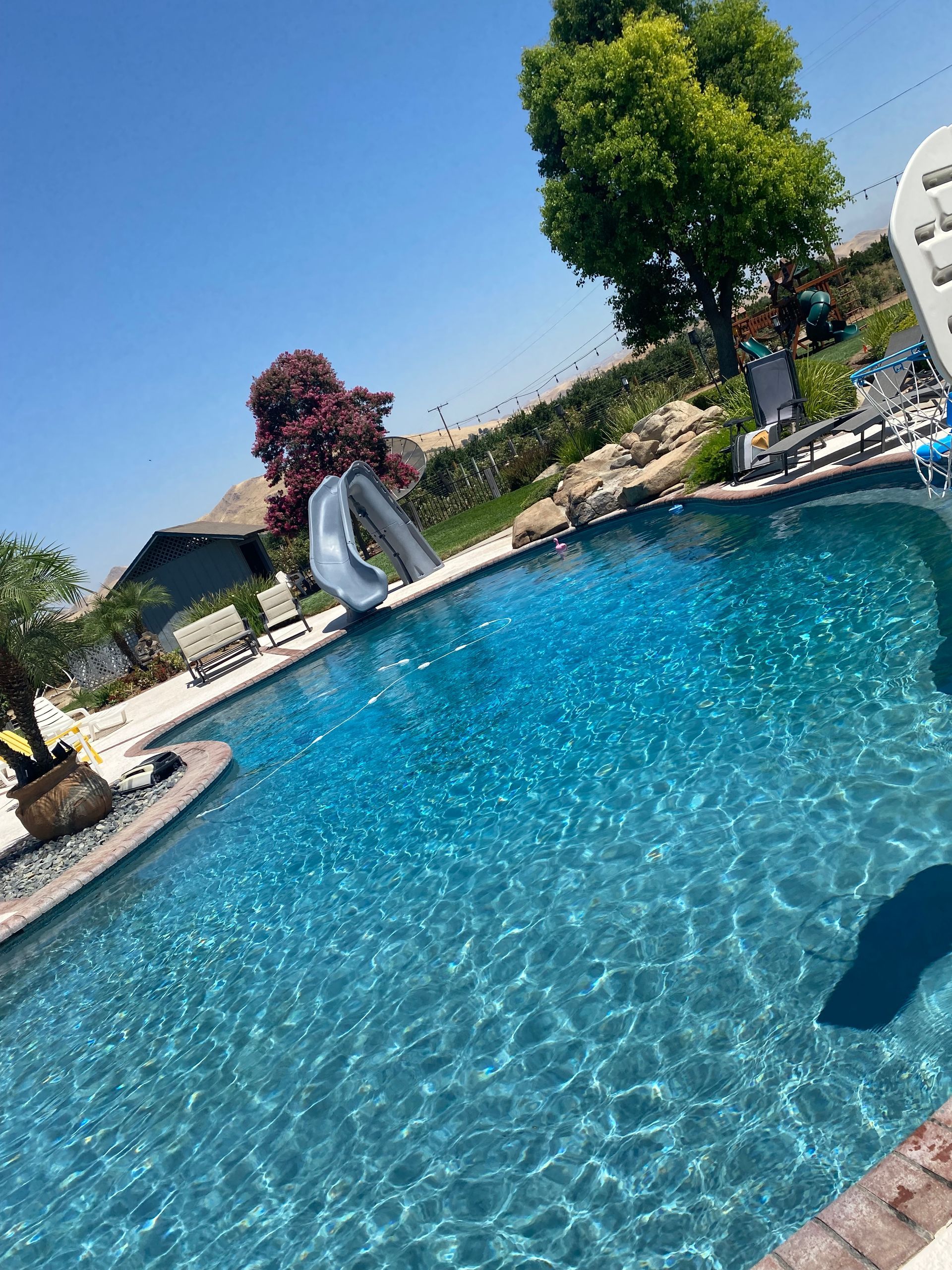 A large swimming pool with a slide in the middle of it.