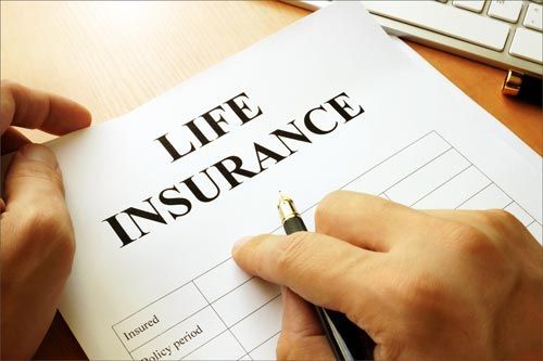 Client Filling Up a Life Insurance Form — Miami, FL — American Quality Assurance Group
