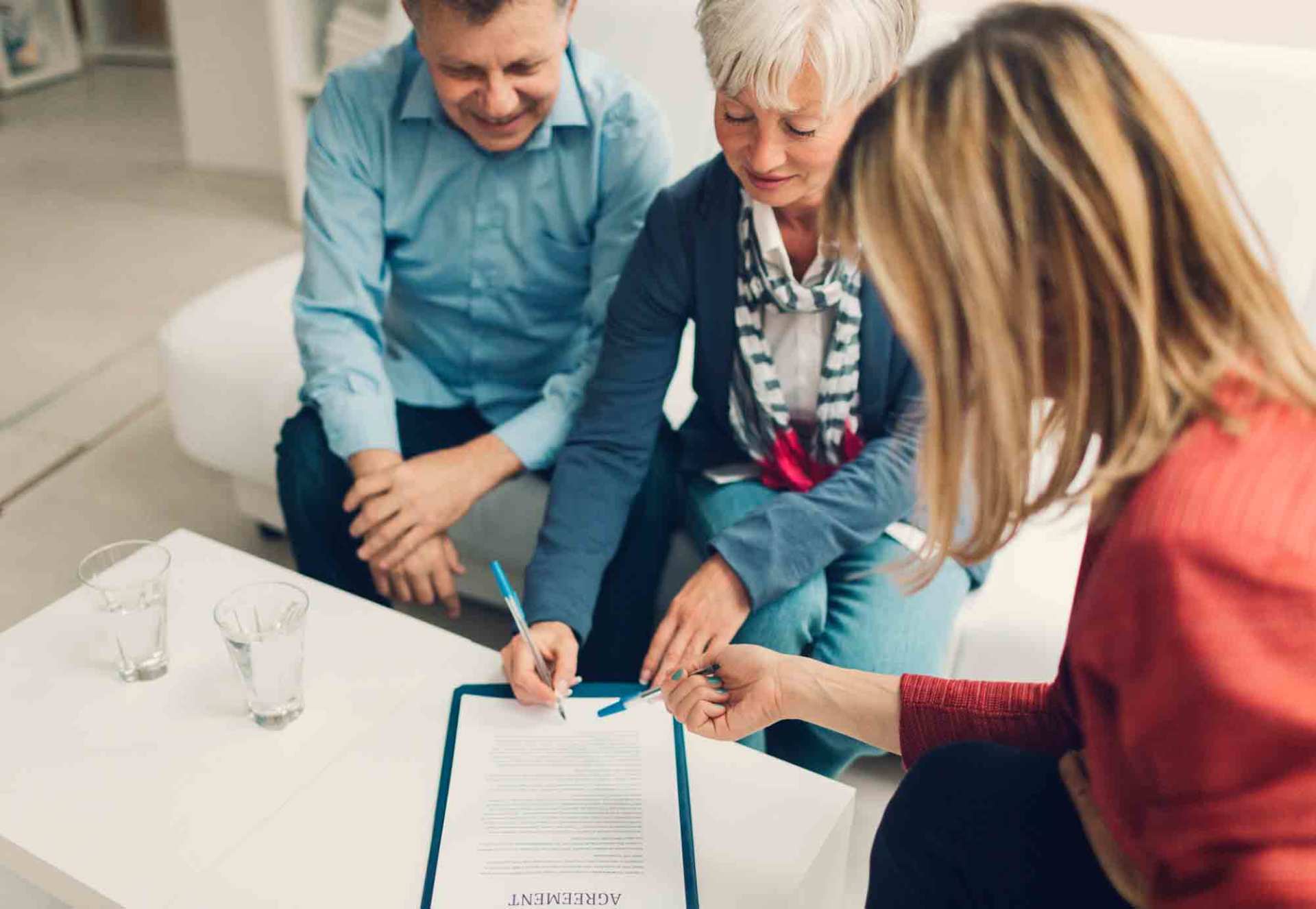 Elder Couple Signing Life Insurance — Miami, FL — American Quality Assurance Group