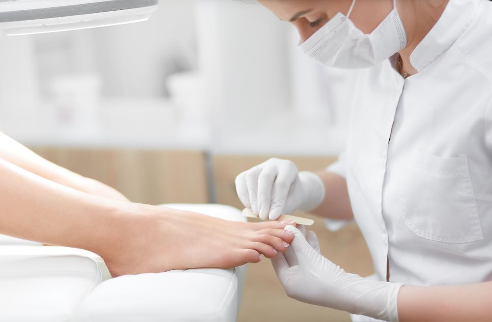 A Woman Is Getting Her Toenails Painted by A Nail Artist — Swan Podiatry and Orthotics in Katherine, NT