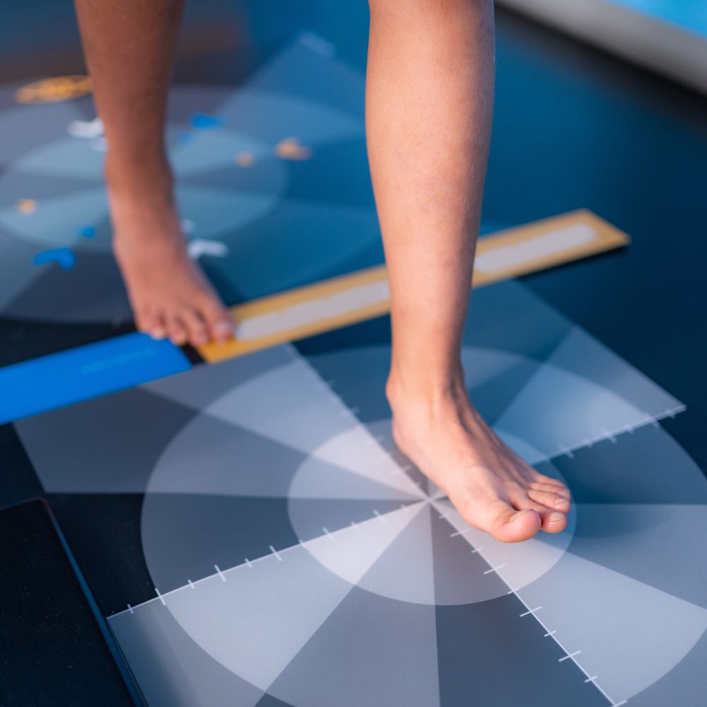A Person's Feet Are Standing on A Checkered Mat — Swan Podiatry and Orthotics in Coconut Grove, NT