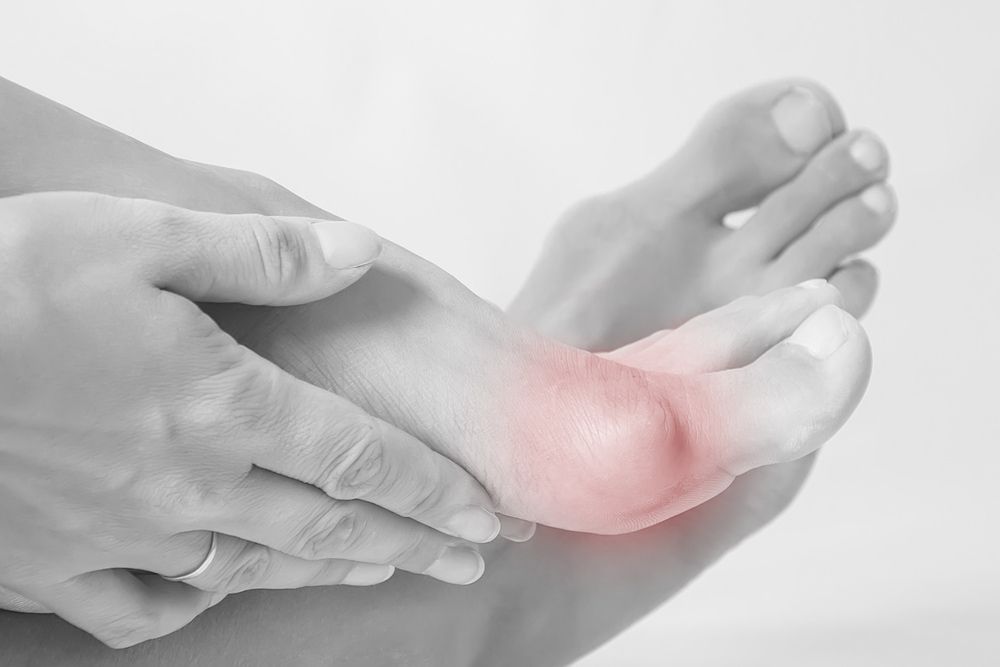 A Person Is Holding Their Foot in Pain — Swan Podiatry and Orthotics in Coconut Grove, NT