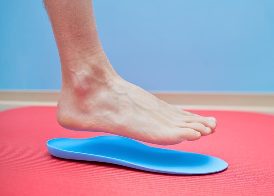 A Person 's Foot Is Standing on A Blue Insole — Swan Podiatry and Orthotics in Coconut Grove, NT