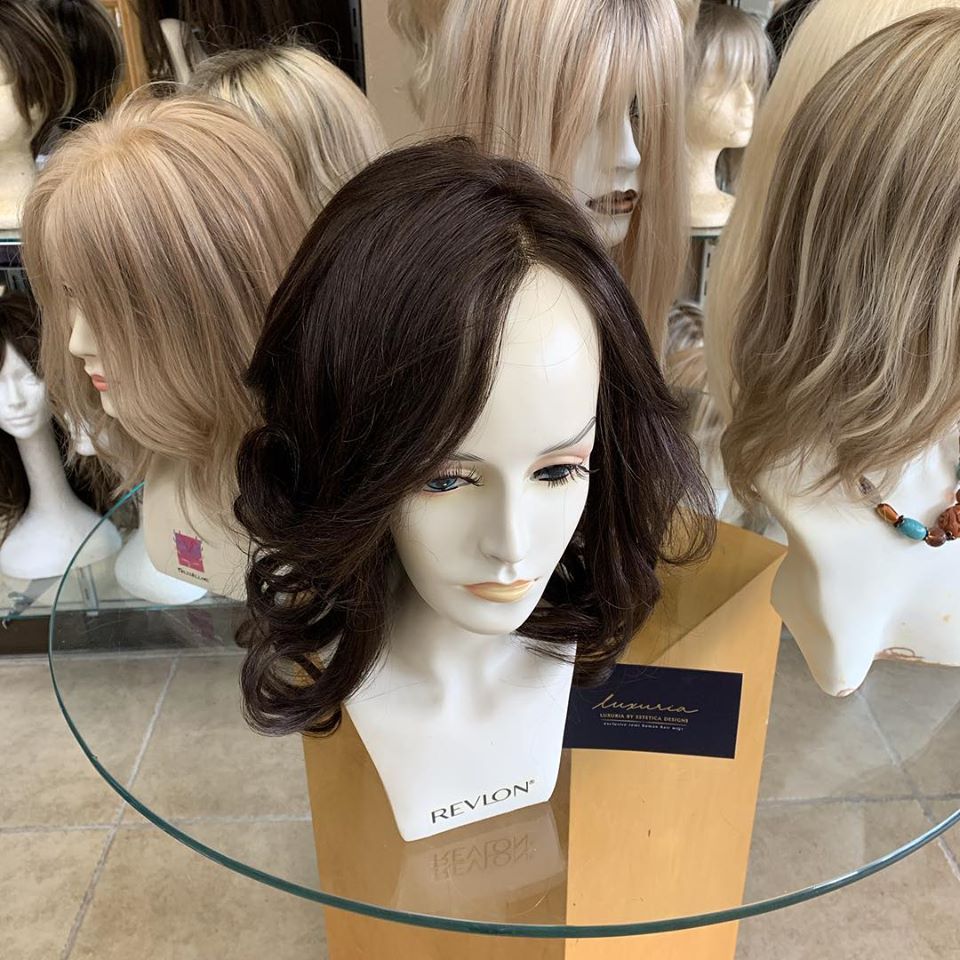 Wigs on Glass Table — Westbury, NY — Wig Wam Hair