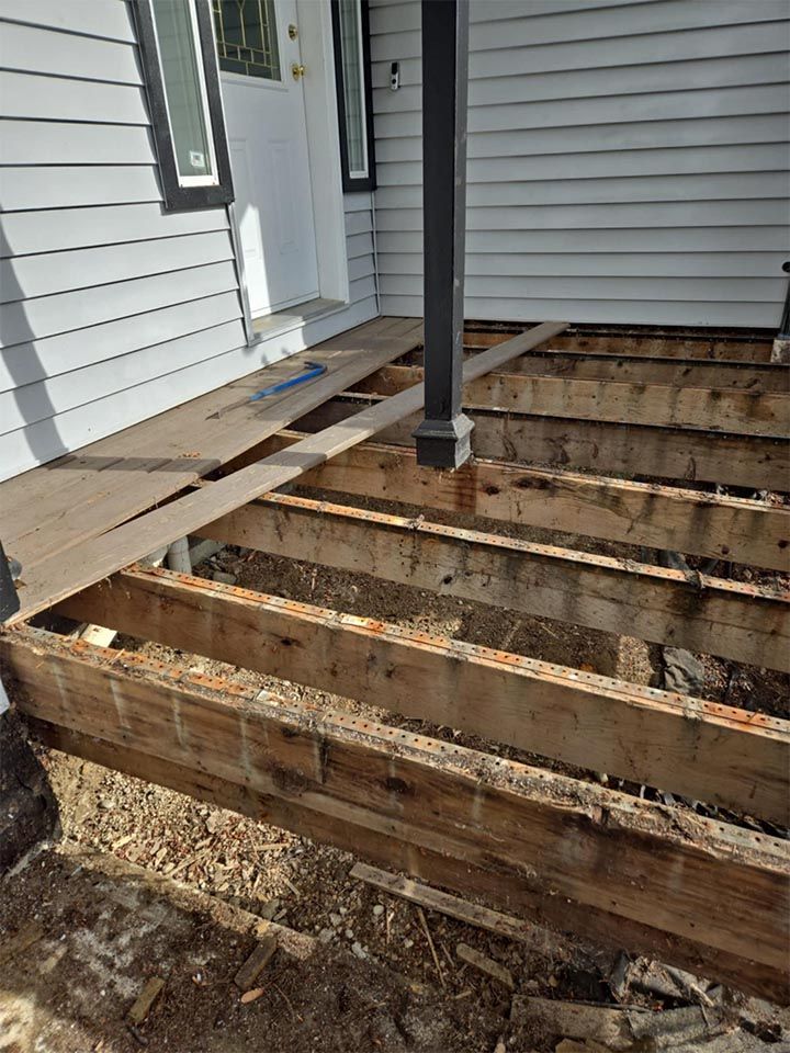 A wooden deck is being built on the side of a house.