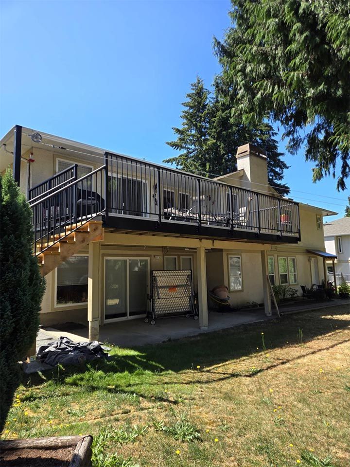 A large house with a large deck in the backyard.