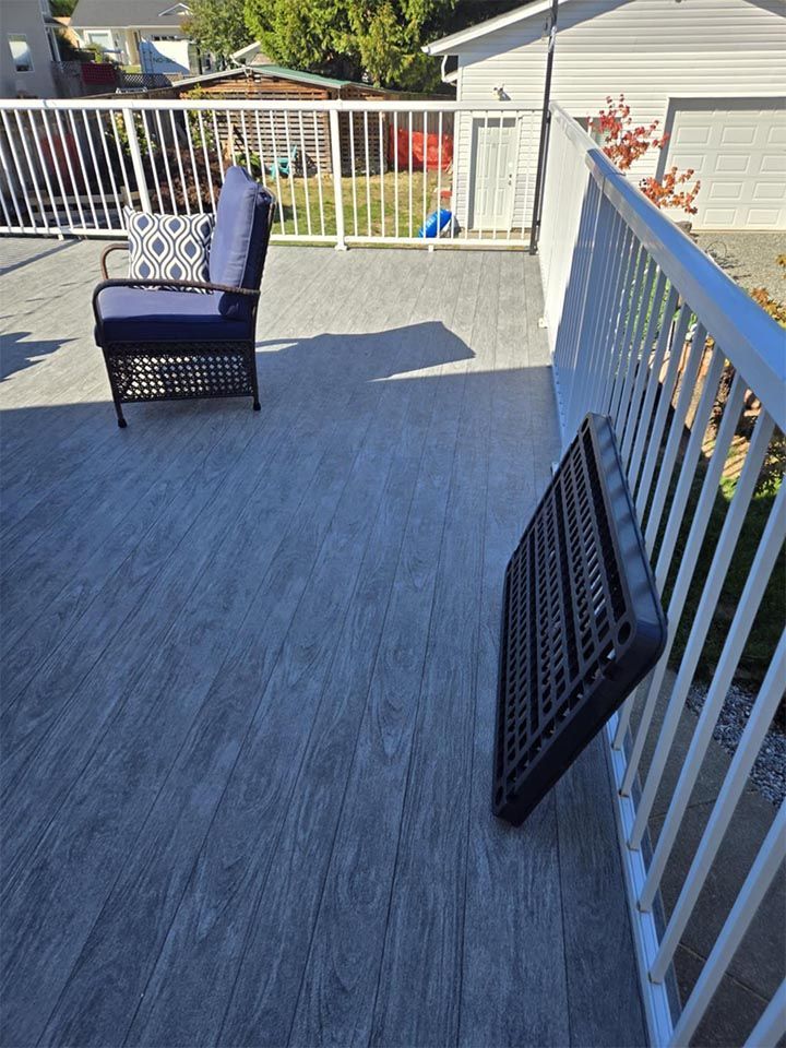 A deck with a chair and a table on it.