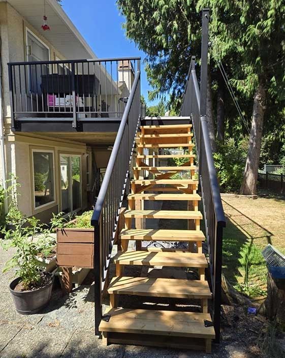 A wooden deck with stairs leading up to it.