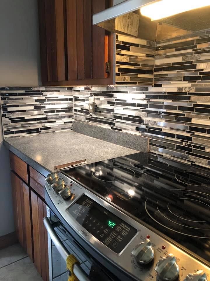 A kitchen with a stove top oven and a counter top.
