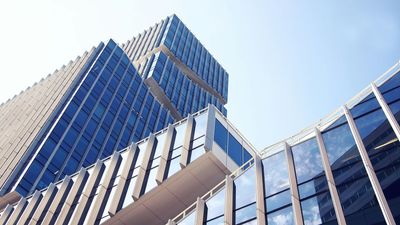 Looking up at a tall building with a blue sky in the background
