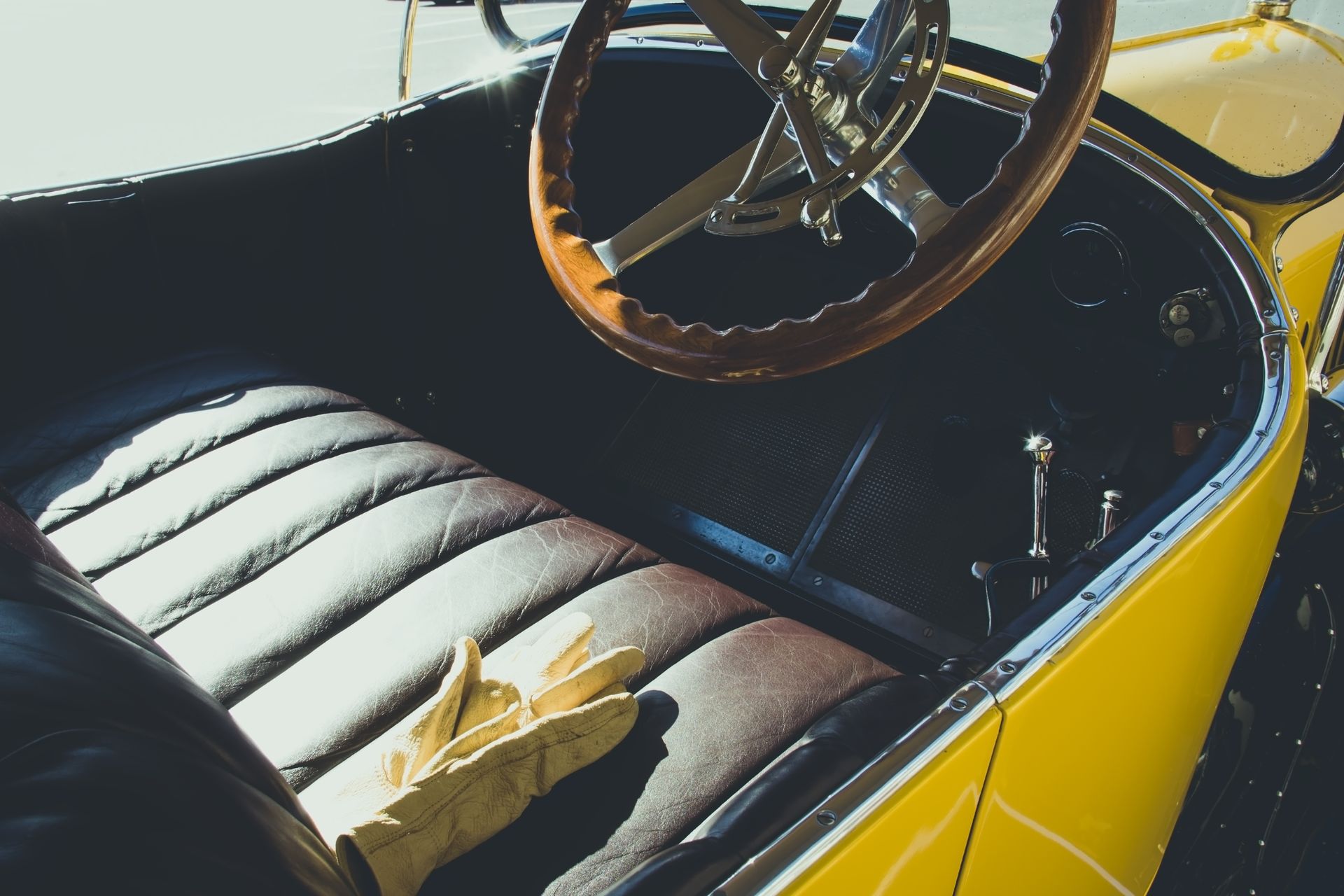 A yellow car with a wooden steering wheel