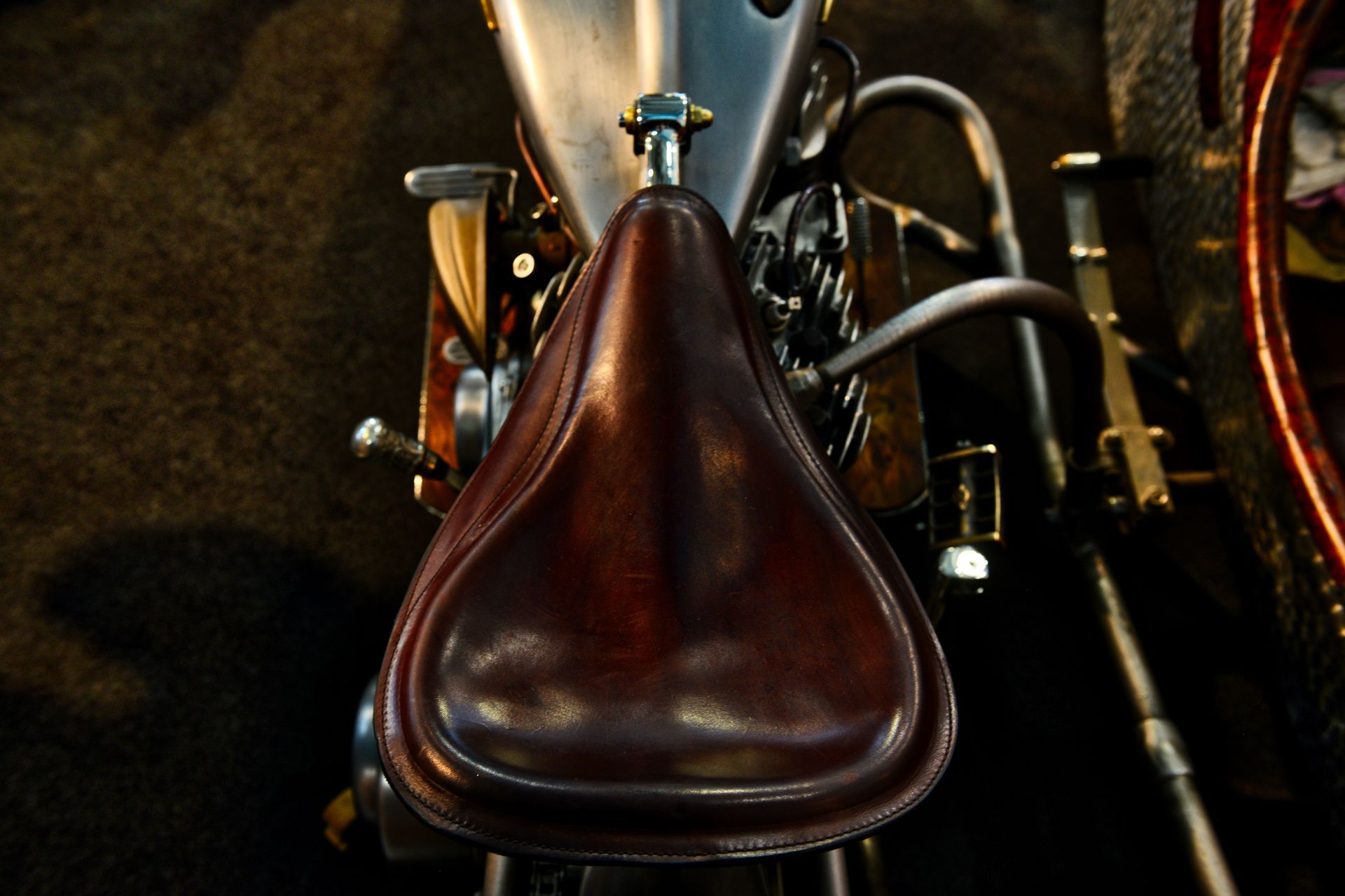 A close up of a brown leather seat on a motorcycle
