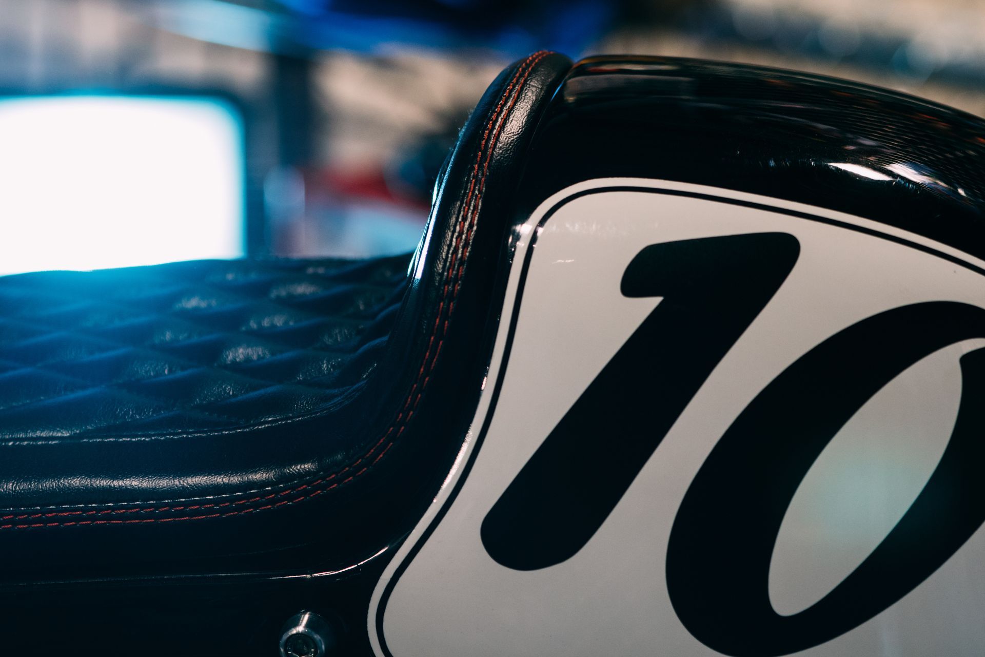 A motorcycle seat with the number 10 on it
