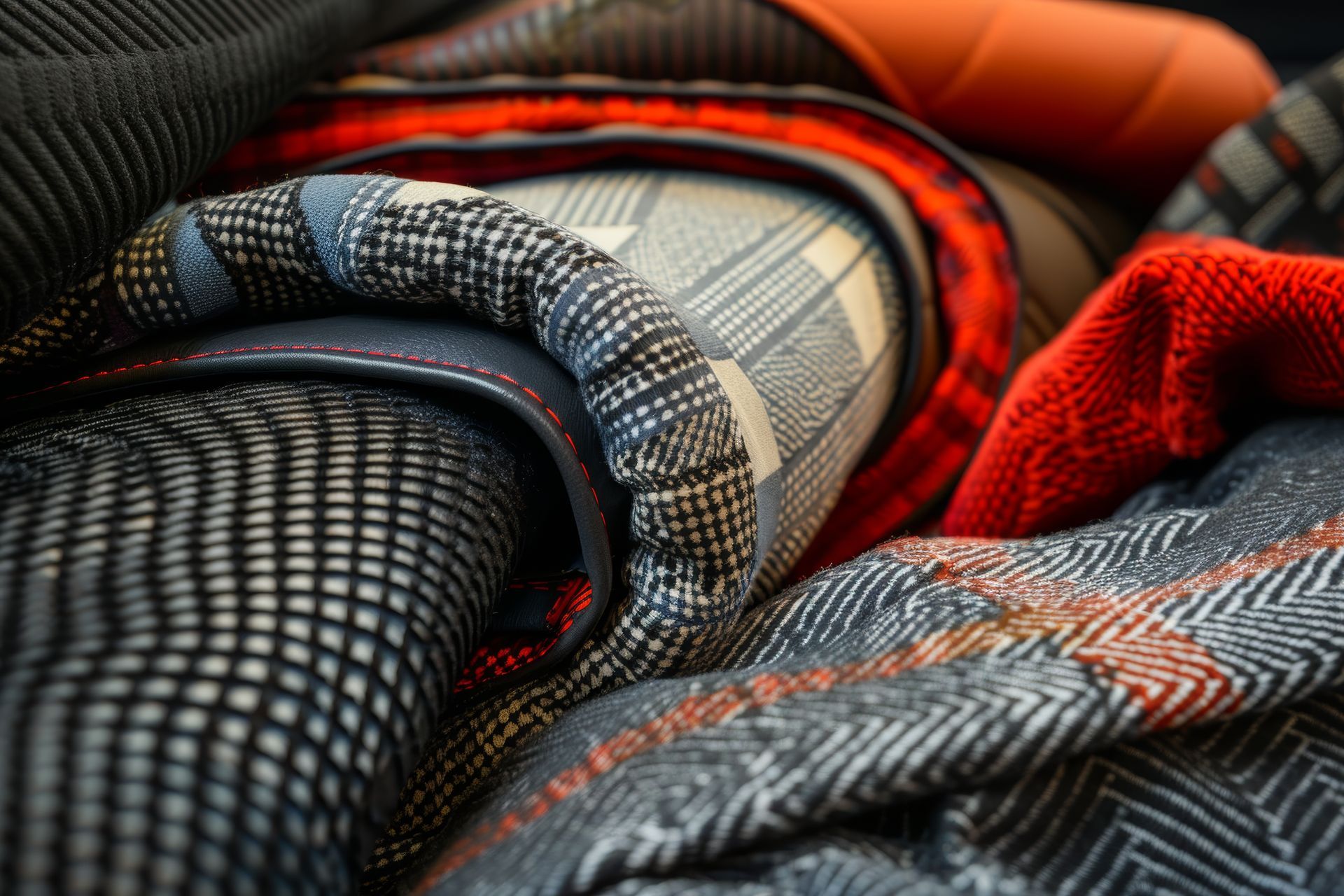 A close up of a pile of blankets on a bed.