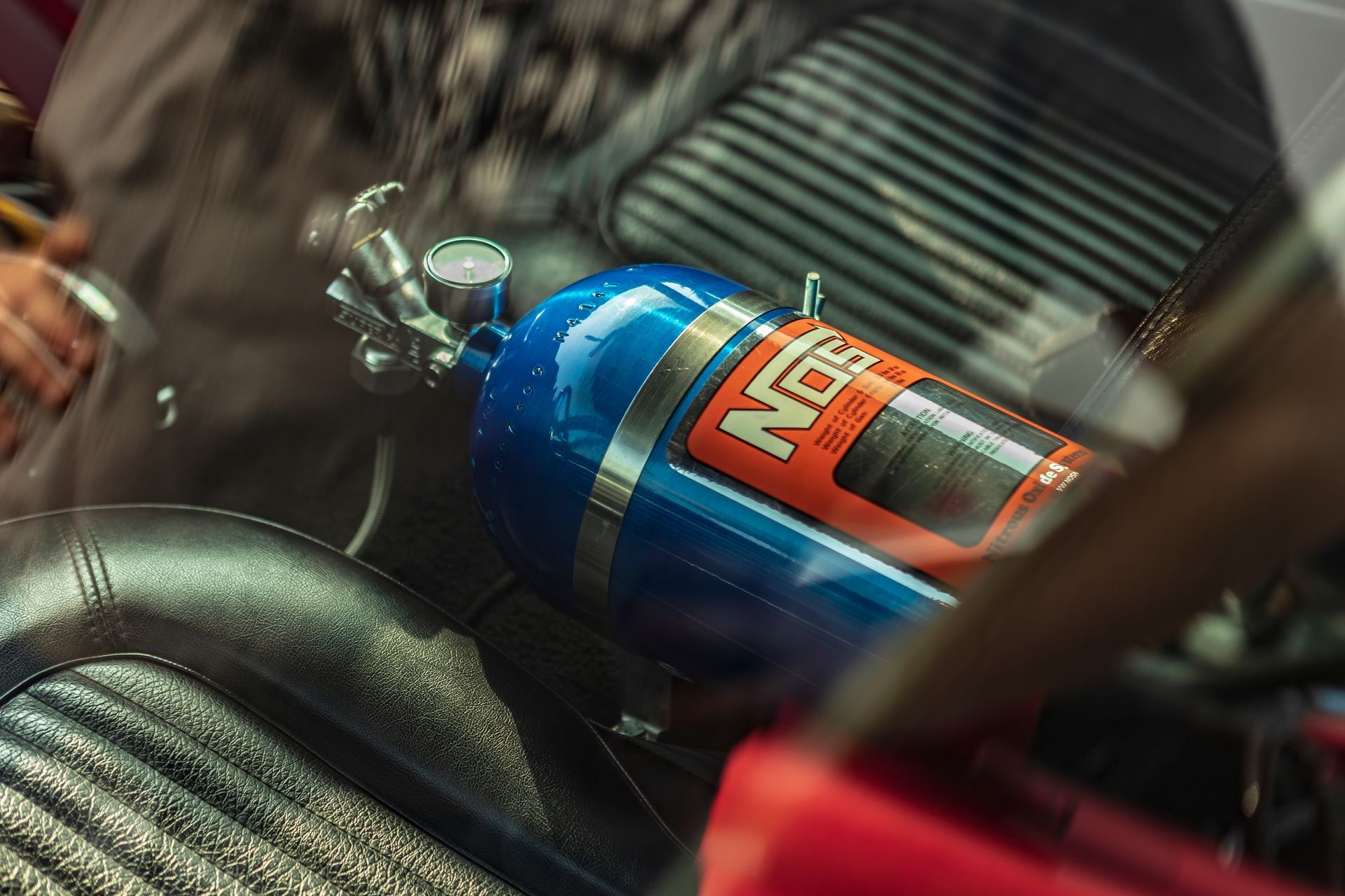 A nitrous bottle is sitting in the back of a car
