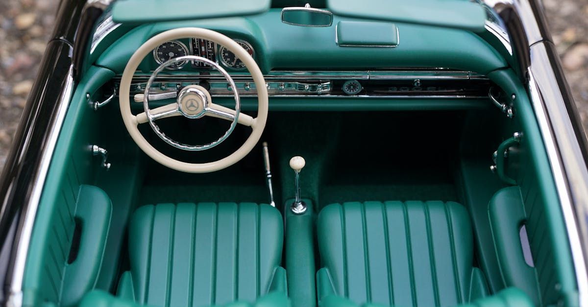 The interior of a car with green seats and a steering wheel.
