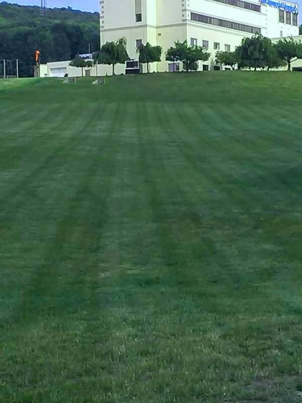 A Large Building Is Behind a Lush Green Field - Tunkhannock, PA - Superior Landscape Management