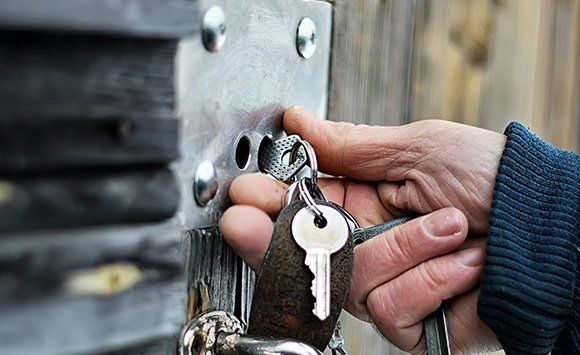 Putting Keys On Wooden Gate — Ottumwa, IA — Mobile Locksmith