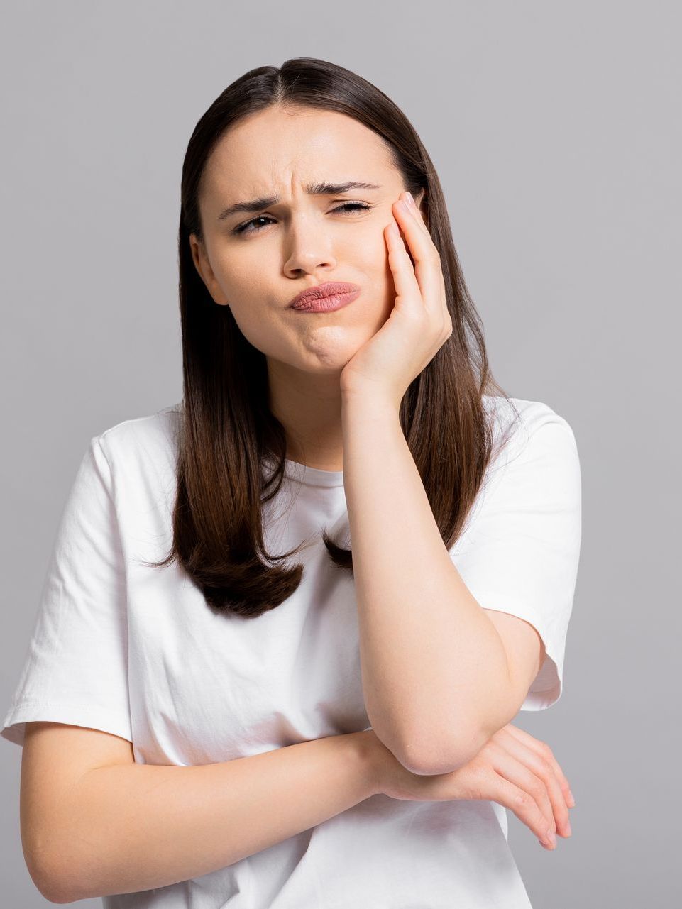 woman in white shirt thinking | Wisdom teeth extractions in Morgantown wv