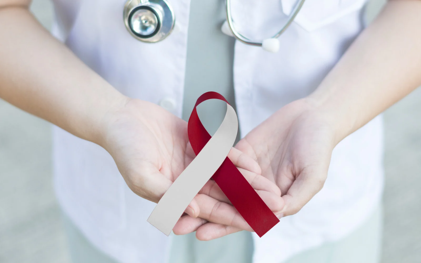 Holding red ribbon | oral cancer screenings at biological dentist in Morgantown WV