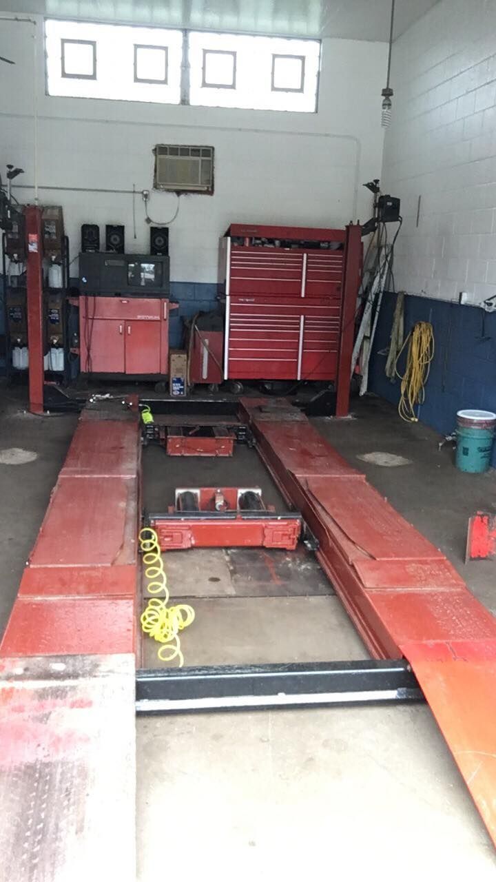 A garage with a lot of tools and a lift