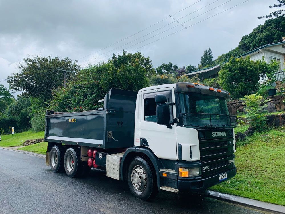 A Dumper is Parked on a Road with Trees in Background — Lifestyle Earthworks & Demolition In Mullumbimby, NSW