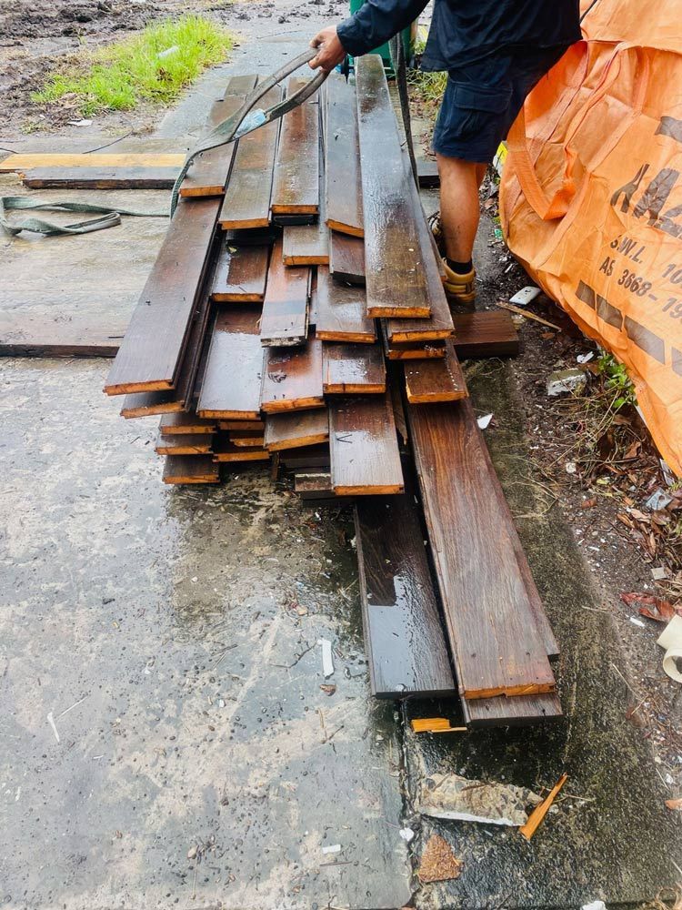 A Yellow Excavator Is Digging a Hole in The Ground — Lifestyle Demolition In Bangalow, NSW