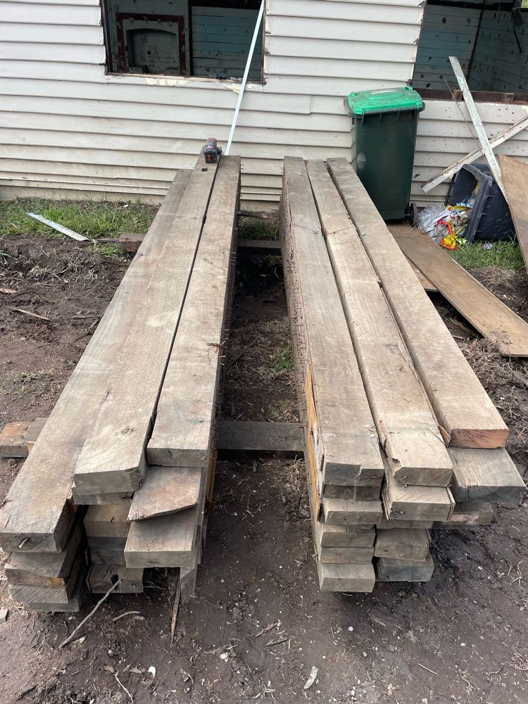 A Bulldozer Is Loading Dirt Into a Truck  — Lifestyle Demolition In Brunswick Heads, NSW