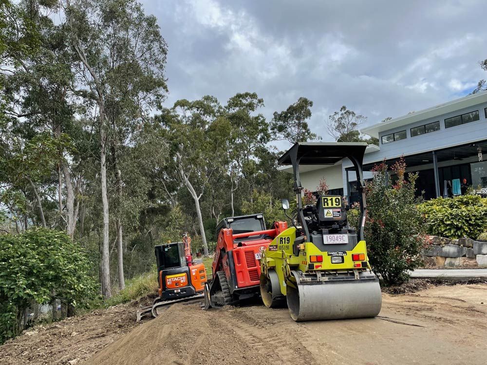 A Bulldozer Is Digging a Hole in The Ground — Lifestyle Demolition in Kingscliff, NSW