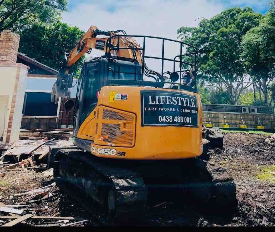 A Large Building Is Being Demolished by A Bulldozer — Lifestyle Demolition In Evans Head, NSW
