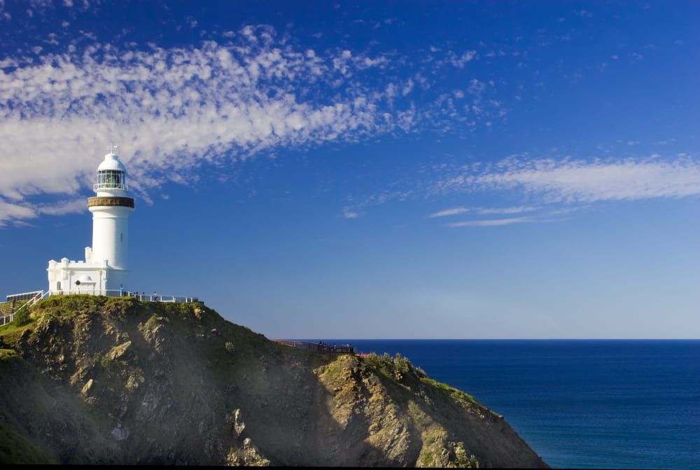A Lighthouse on Top of A Cliff Overlooking the Ocean — Lifestyle Demolition In Byron Bay, NSW