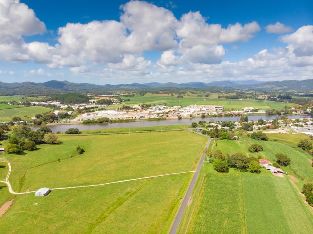 An Aerial View of A Lush Green Field with A River In The Background — Lifestyle Demolition in Murwillumbah, NSW
