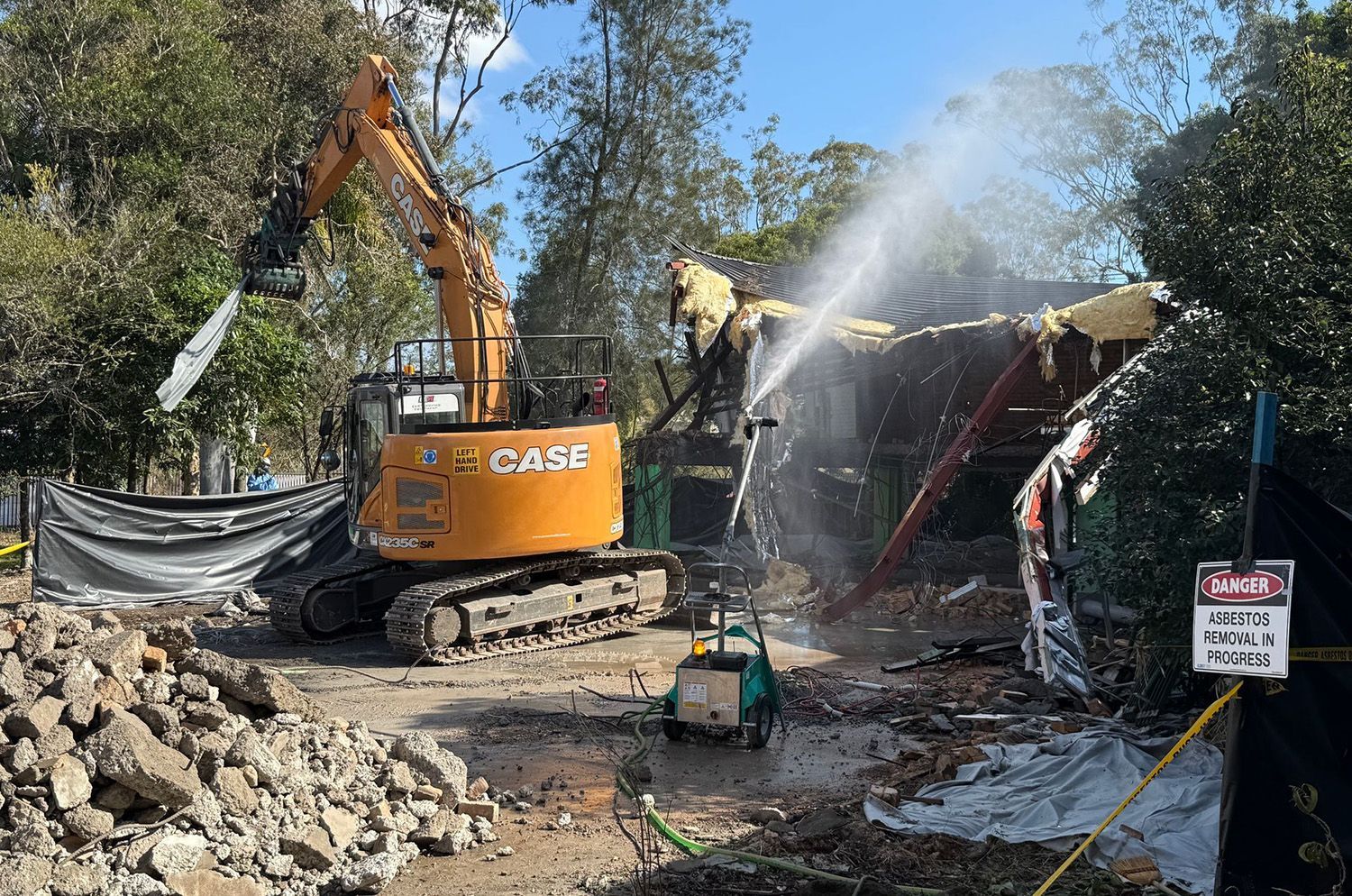 An Orange Case Excavator Demolishes A Structure