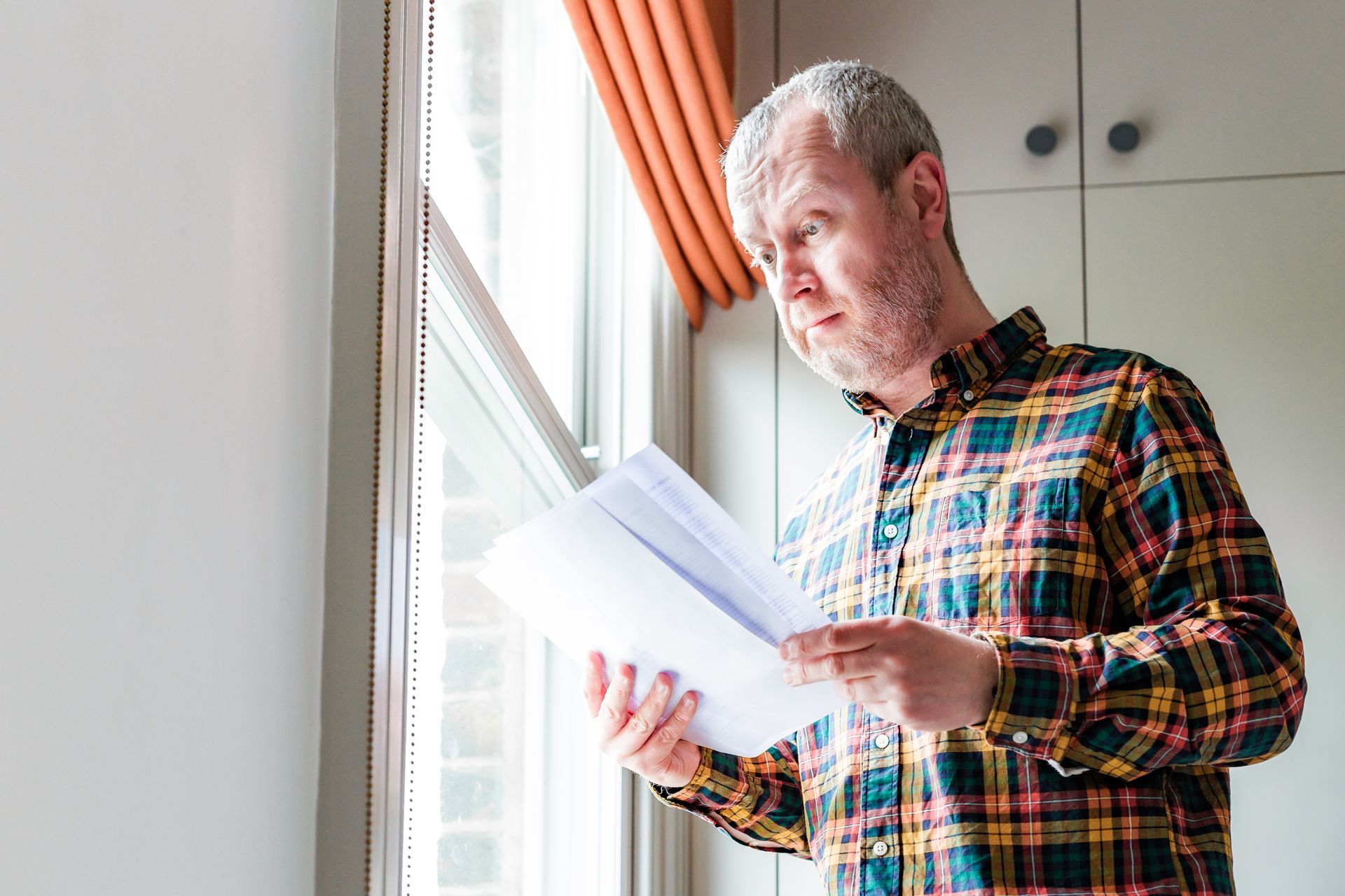 Man reads legal documents after being improperly served