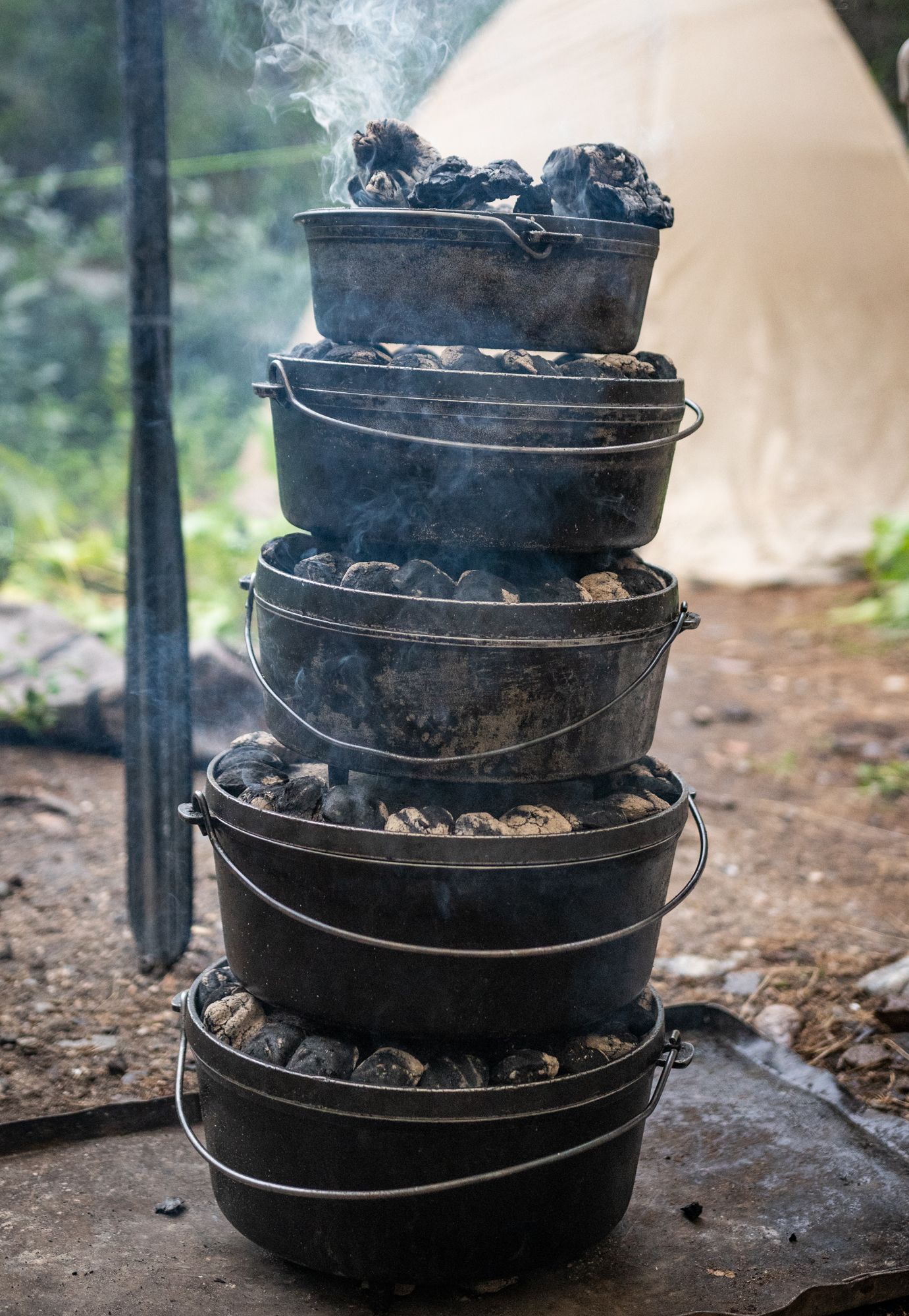 A stack of pots and pans filled with coals.