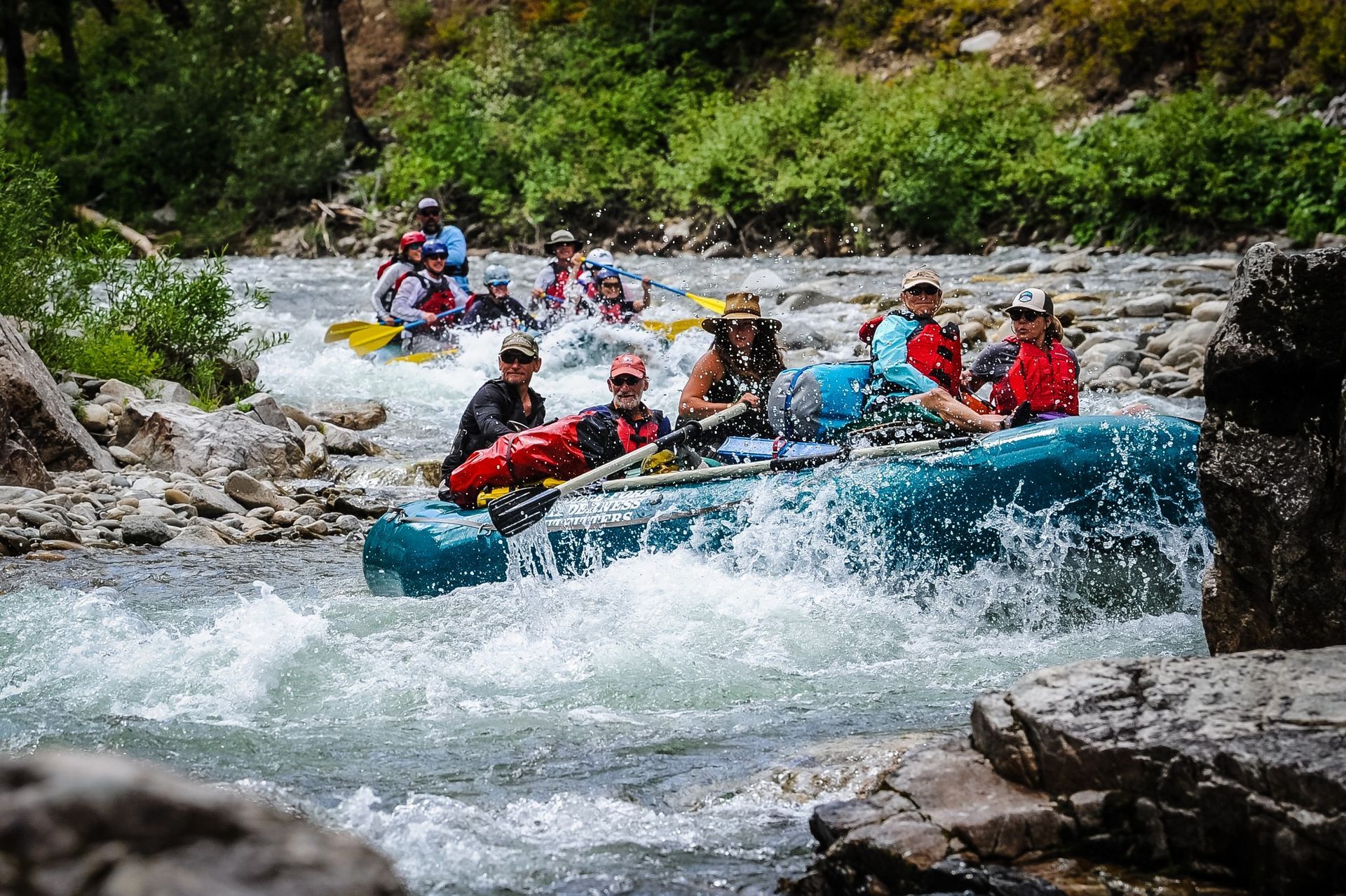 A group of people are rafting down a river.